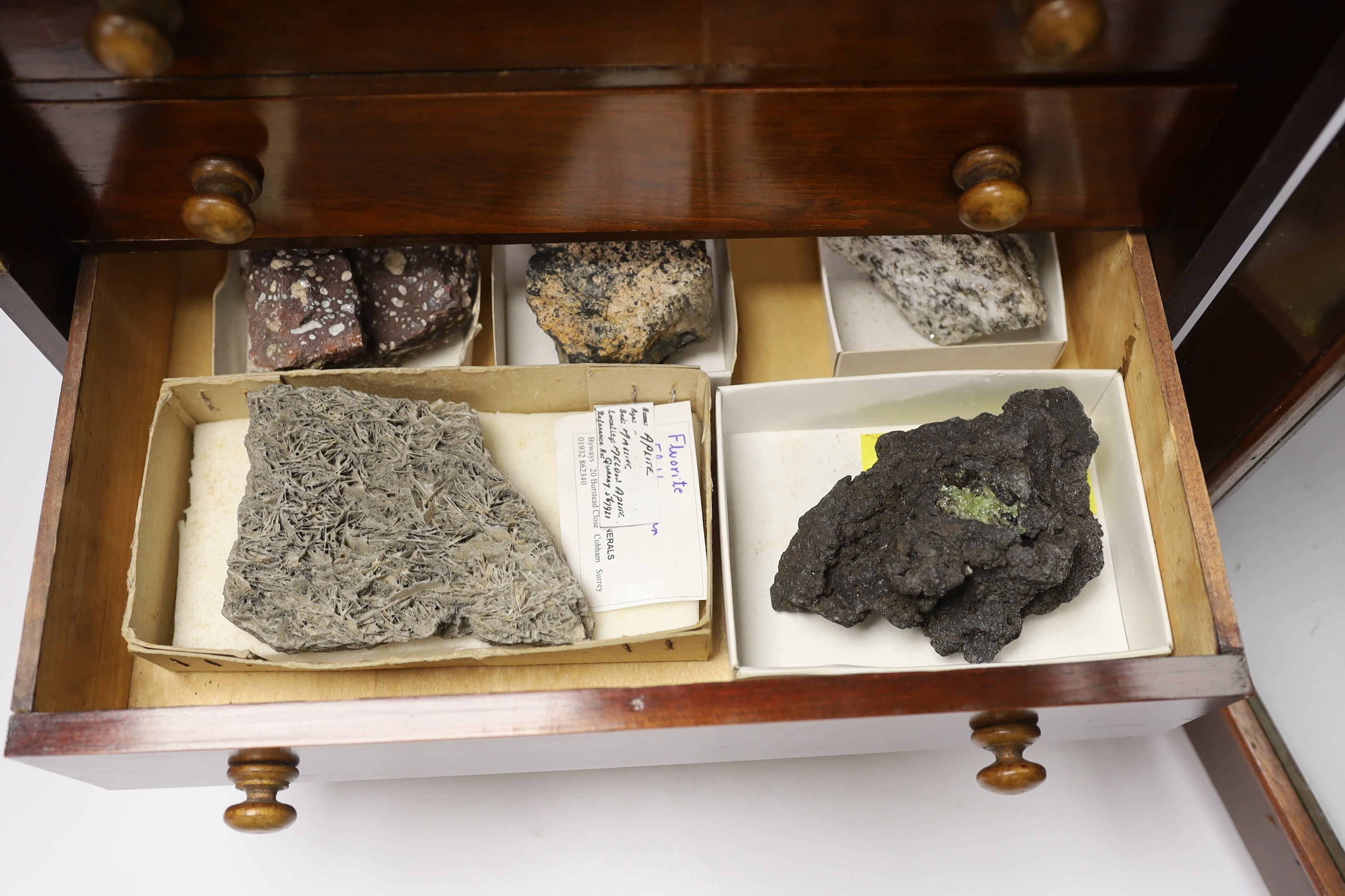 An early twentieth century six drawer pine collector’s cabinet of mineral and crystal samples including; Amber and insects in amber, Baryteson Calcite, Aplite, Nodular Rhyolite, Desert Roses, etc. many specimens with lab